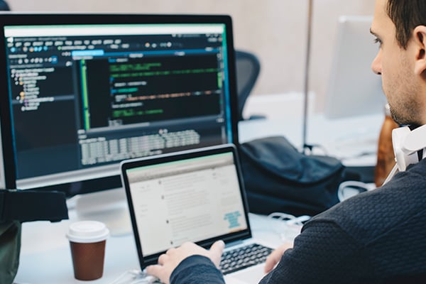 Person looking at multiple work screens