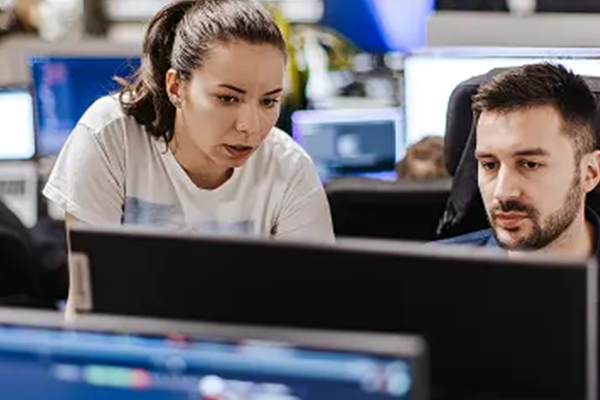 Two people looking at computer screen