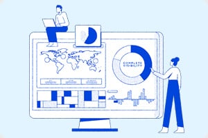 A person sits on a desk with a laptop, and another interacts with a large screen displaying a world map, charts, and 